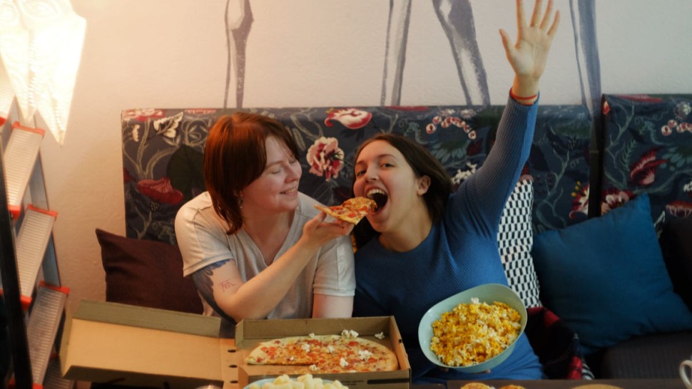 Two women eating junk food
