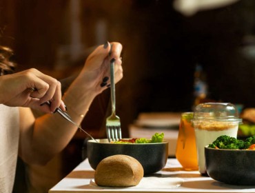 Concentrated young woman eating her dinner