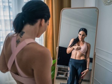 Young woman looking at herself in a mirror
