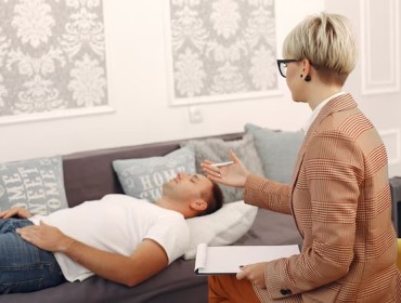 Patient lying on sofa in hypnosis session