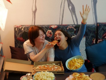 Two women eating junk food